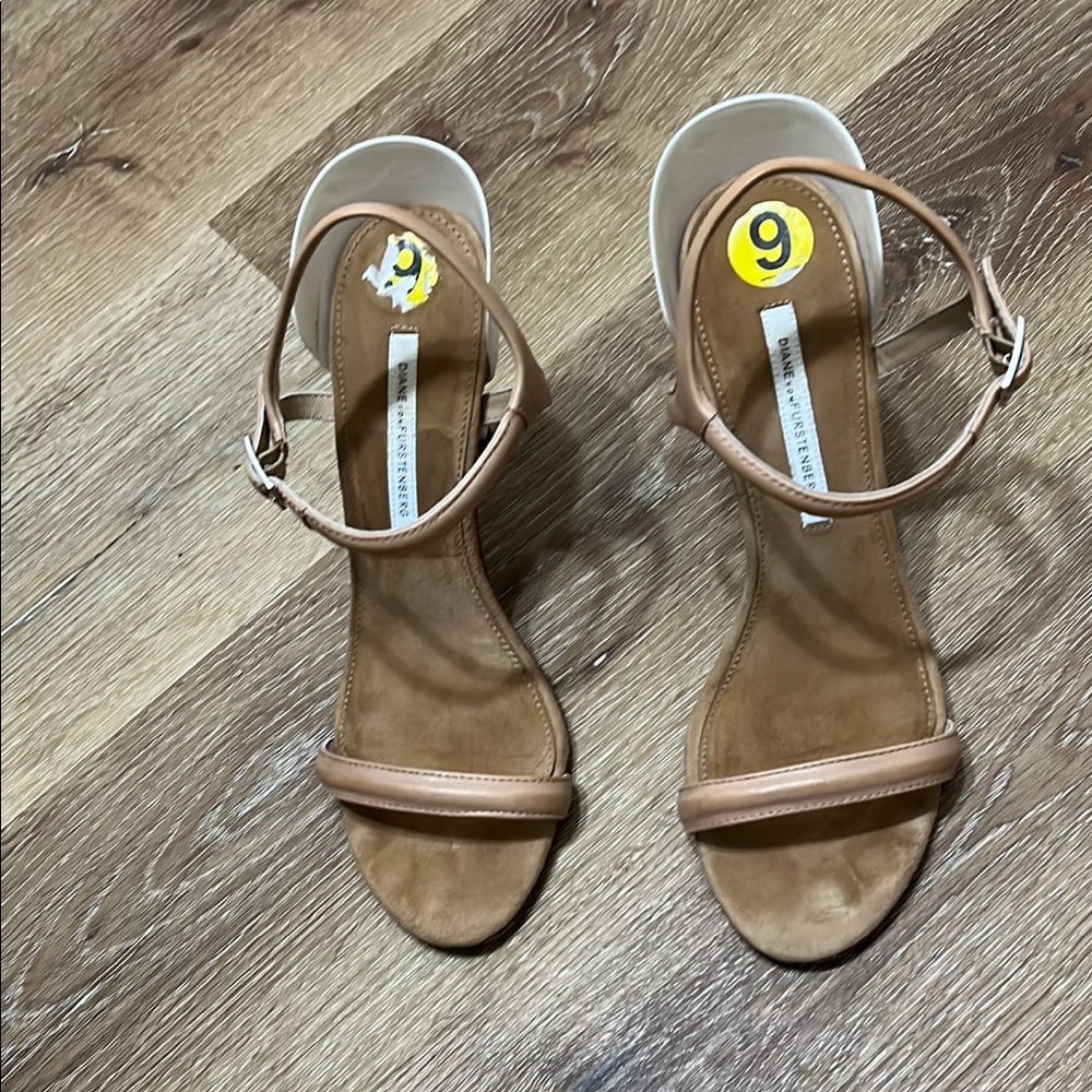 Tan high-heeled sandals with strappy design and slender heel